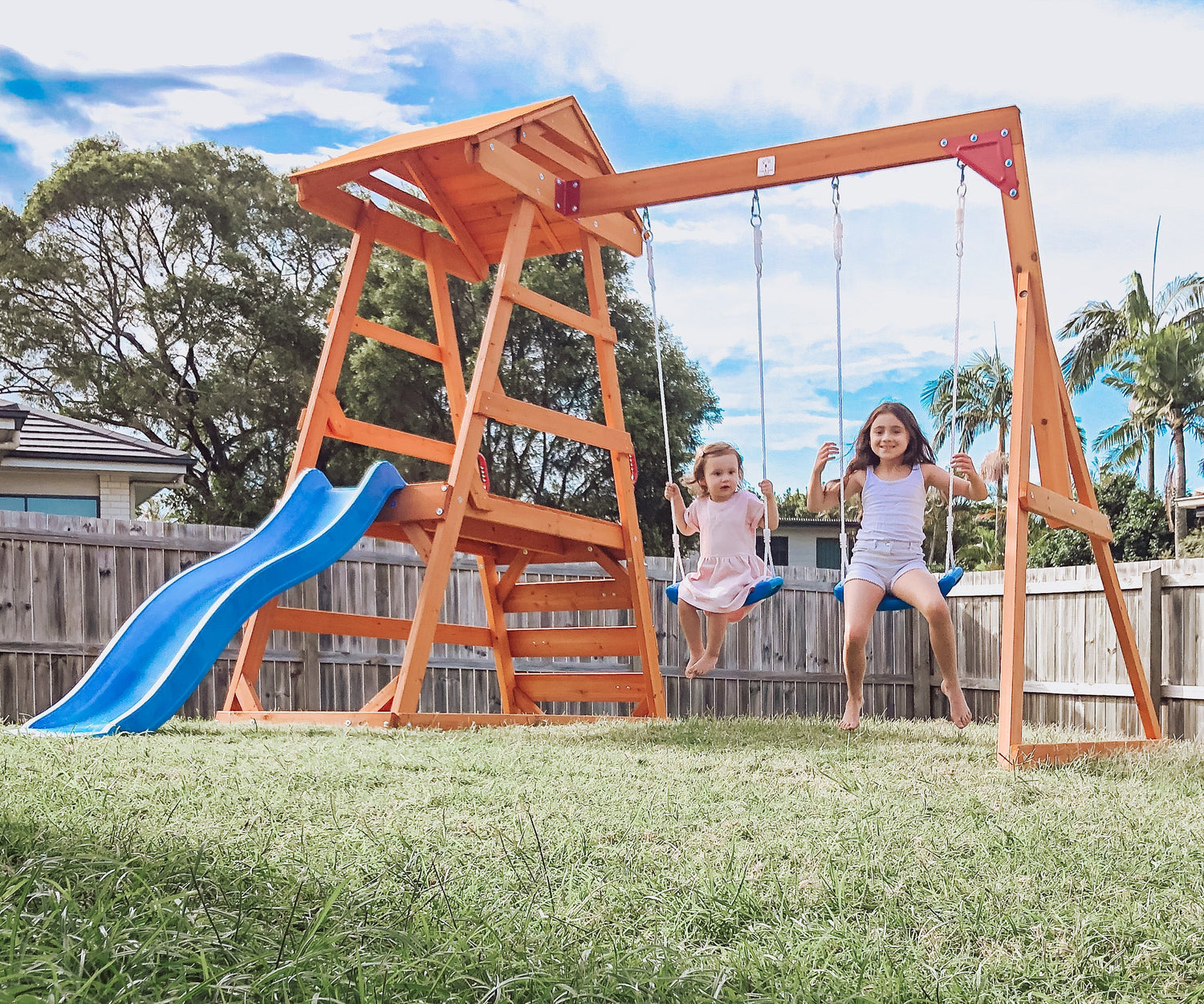 Happy children playing outdoors with Hide & Seek Kids' play equipment.