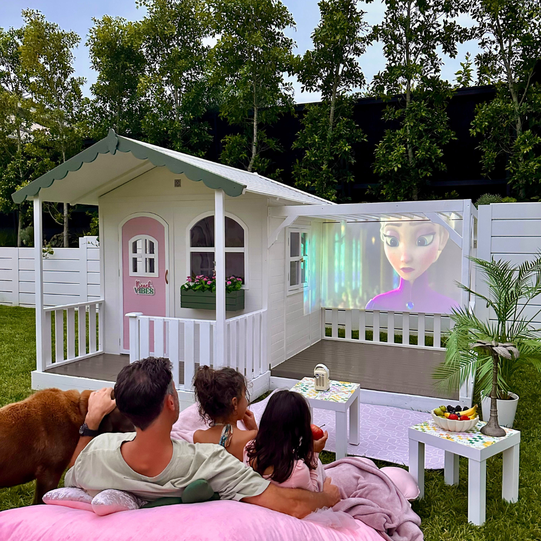 A video of the Billie Grand Cubby House by Hide & Seek Kids – Pergola Add-on installed and a outdoor cinema setup.