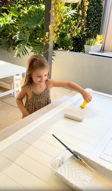 Young child engaged in creative painting activity at a wooden Billie Grand easel from Hudson Harlow kids furniture collection