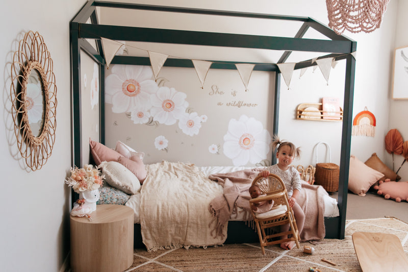 Cubby House Montessori floor bed setup in little girls bedroom.