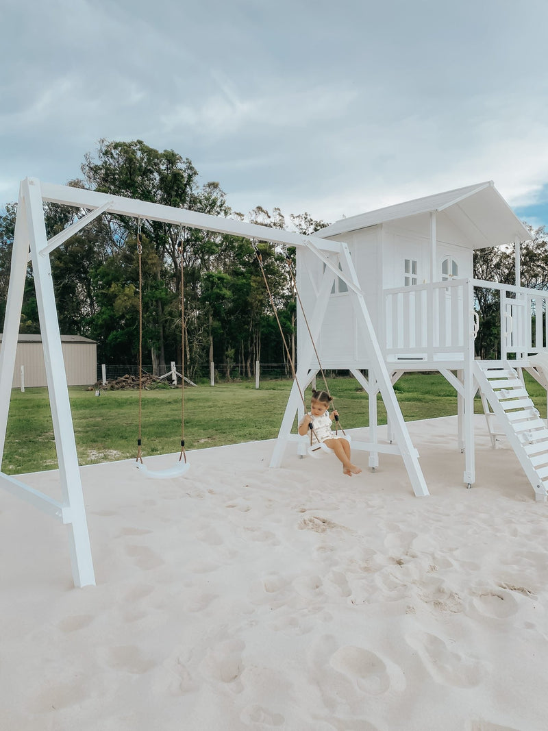 Marlie Cubby playhouse and Lucas Swing Set outdoor playset for children in backyard garden setting