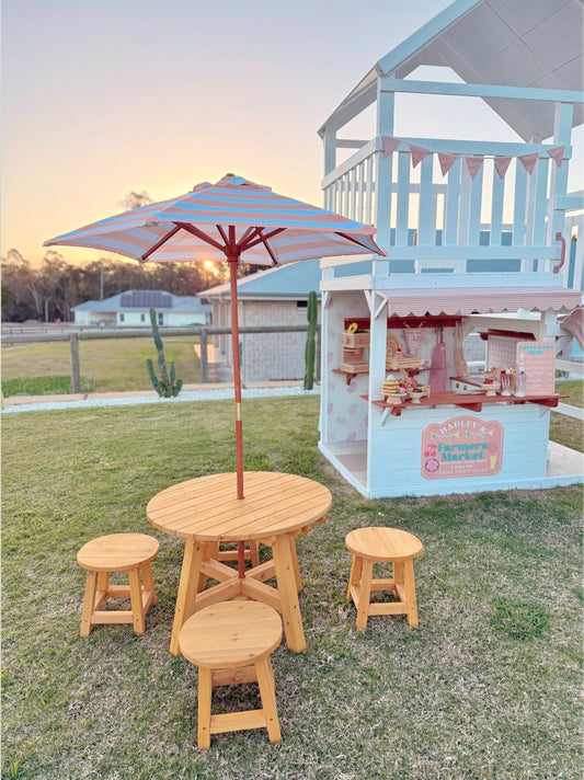 Round kids timber picnic table with colourful umbrella and four stools in backyard - Hide & Seek Kids