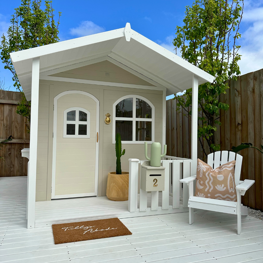 Billie Grand Cubby House by Hide & Seek Kids – white timber cubby with veranda and large arched windows