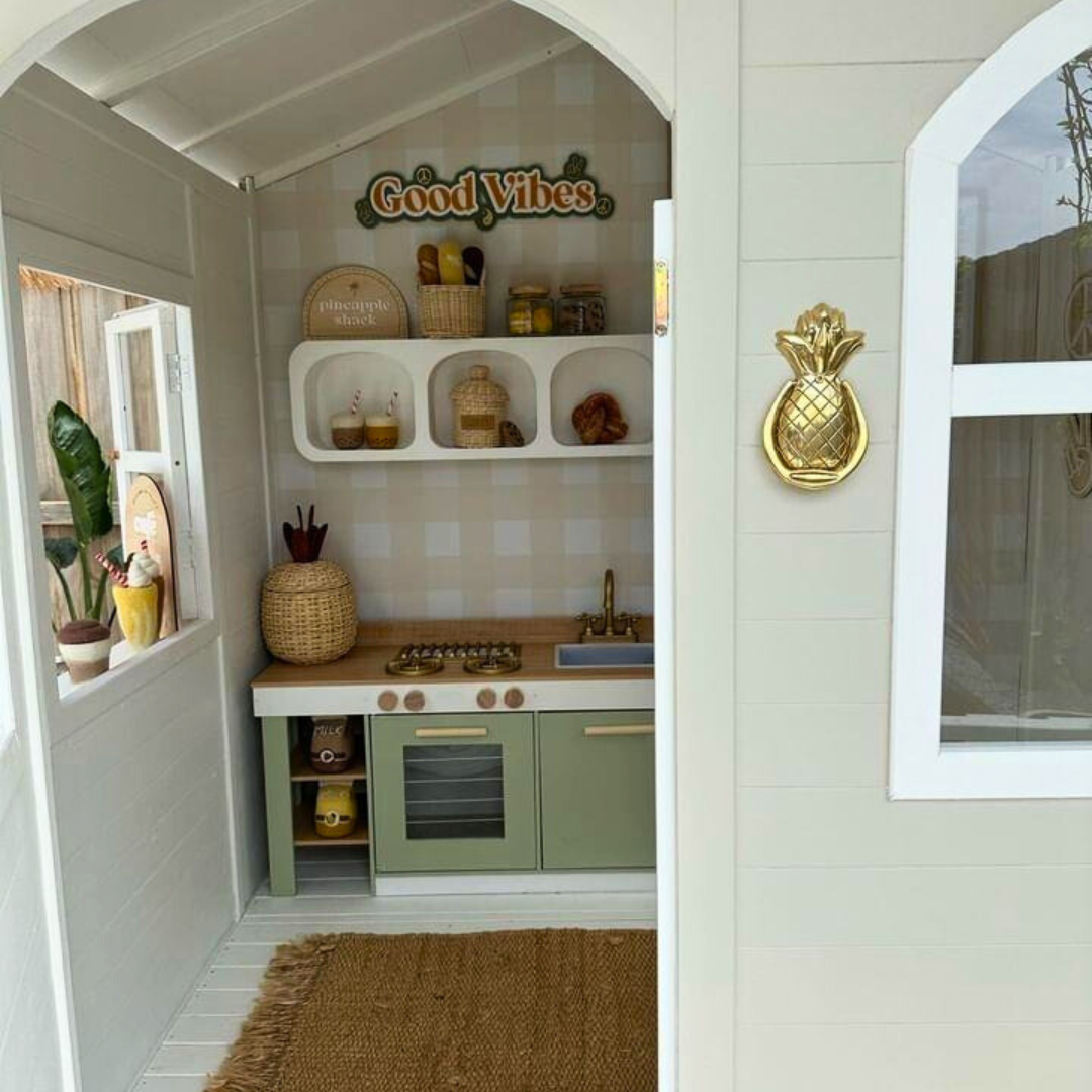 Looking inside the Billie Grand Cubby House by Hide & Seek Kids – painted timber cubby, wallpaper by Little Abode Interiors, Mud Kitchen